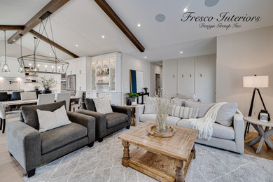 Inspiration for a mid-sized country open concept vinyl floor, brown floor and exposed beam living room remodel in Other with white walls, a standard fireplace, a wall-mounted tv and a shiplap fireplace