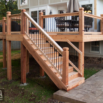Leeder - Cedar deck in Kansas City with stamped concrete patio and firepit.
