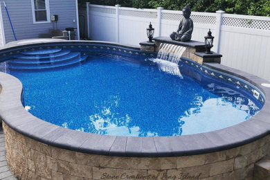 Photo of a large contemporary back custom shaped above ground swimming pool in New York with a water feature and concrete paving.