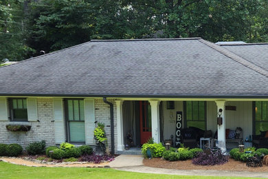 Mid-sized traditional white one-story brick exterior home idea in Atlanta with a shingle roof and a black roof