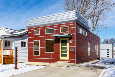 Exemple d'une façade de maison rouge moderne de taille moyenne et de plain-pied avec un revêtement mixte et un toit plat.
