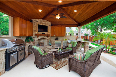 Example of a huge tuscan backyard concrete patio kitchen design in Orange County with a gazebo