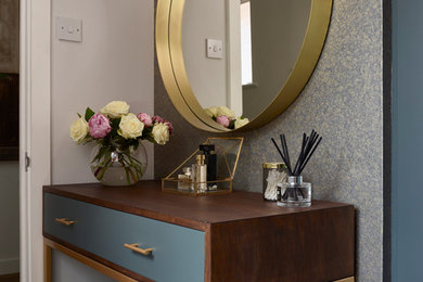 Example of a minimalist gender-neutral carpeted and gray floor dressing room design in Essex with flat-panel cabinets and gray cabinets