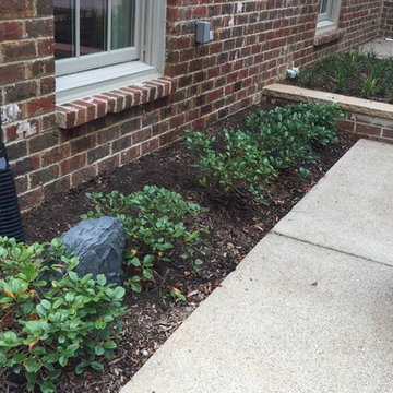 Rock speakers in the flowerbed.