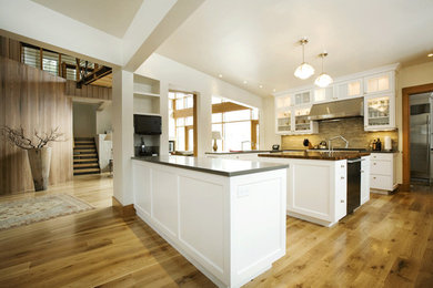 Trendy l-shaped medium tone wood floor kitchen photo in Denver with glass-front cabinets, white cabinets, wood countertops, stainless steel appliances and an island