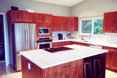 Kitchen pantry - large modern l-shaped laminate floor and beige floor kitchen pantry idea in Vancouver with an undermount sink, shaker cabinets, medium tone wood cabinets, quartzite countertops, stainless steel appliances and an island