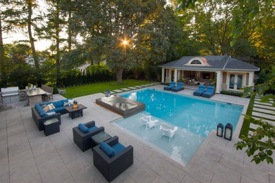 Design ideas for a mid-sized contemporary side yard rectangular lap pool in Toronto with a pool house and concrete slab.