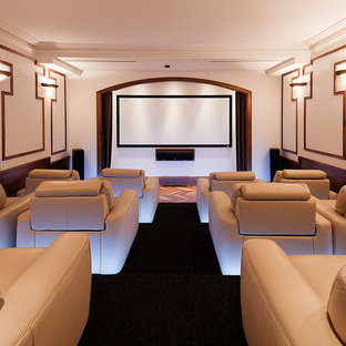 Example of a large transitional enclosed carpeted and black floor home theater design in Melbourne with white walls and a projector screen