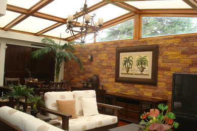 This is an example of a tropical porch design in Baltimore.