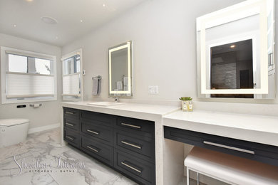 Example of a mid-sized trendy master white tile and porcelain tile porcelain tile bathroom design in Other with shaker cabinets, gray cabinets, a one-piece toilet, white walls, a drop-in sink and quartz countertops