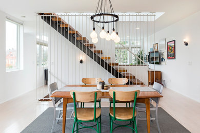 Example of an eclectic dining room design in Portland with white walls