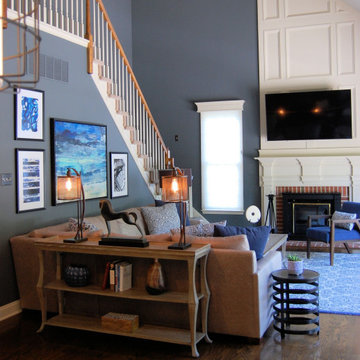 Family room showing console table at back of sectional and wall of artwork with
