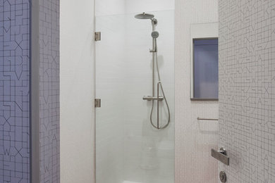Design ideas for a contemporary bathroom in New York with an alcove shower and light hardwood floors.