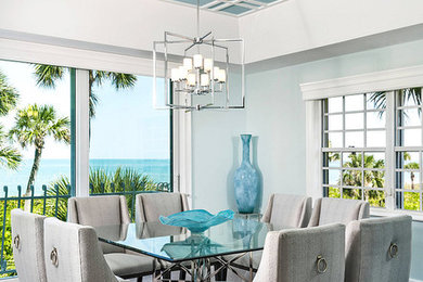 Inspiration for a large coastal dark wood floor and gray floor enclosed dining room remodel in Miami with blue walls and no fireplace
