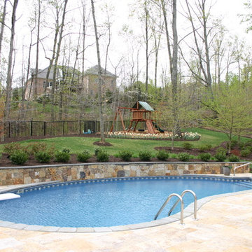 Natural Pool with Travertine Deck & Stone Retaining Wall