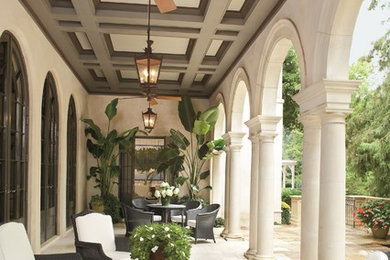 Patio - large transitional side yard tile patio idea in New Orleans with a roof extension