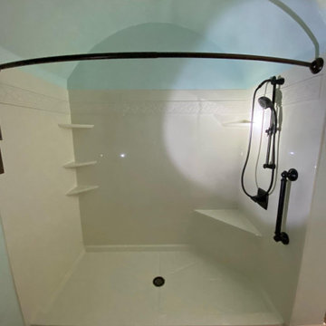Cream Acrylic Walk-In Shower with Black Matte Fixtures and Corner Bench