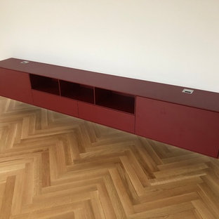 Home theater - mid-sized contemporary medium tone wood floor home theater idea in Frankfurt with white walls