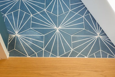 Design ideas for a medium sized modern study in Cambridgeshire with blue walls, ceramic flooring and a built-in desk.