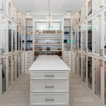 Luxury Walk-In Closet with Glass Cabinetry and Island