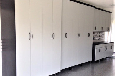 Inspiration for a mid-sized industrial attached three-car garage remodel in Houston