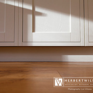 Ivory Mackintosh kitchen with stunning copper glass splashback