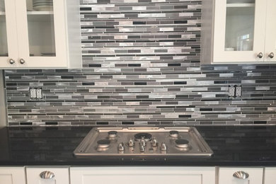 Mid-sized trendy eat-in kitchen photo in Birmingham with granite countertops, multicolored backsplash, glass tile backsplash and an island