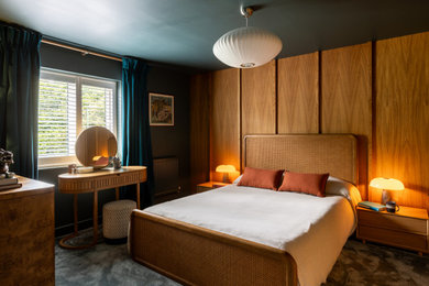 Design ideas for a medium sized midcentury master bedroom in Sussex with blue walls, carpet, blue floors, panelled walls and a feature wall.
