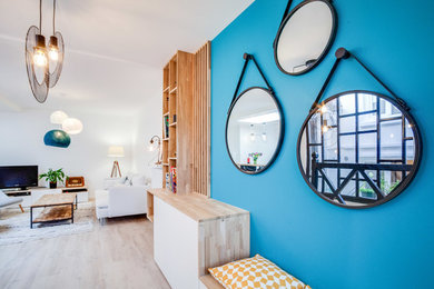 Inspiration pour un grand salon design ouvert avec une bibliothèque ou un coin lecture, un mur bleu et parquet clair.
