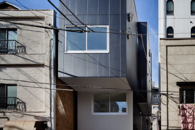 Inspiration for a small modern three-storey concrete black apartment exterior in Tokyo with a flat roof.