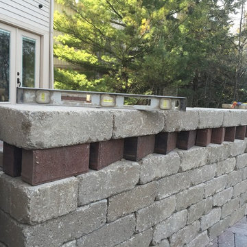 Outdoor Kitchen with  fireplace, dining area and seating wall