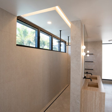 A modern style bathroom achieved with trim-free windows and recessed lighting.