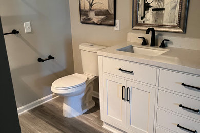 Inspiration for a large contemporary master gray tile laminate floor, gray floor and double-sink bathroom remodel in Other with recessed-panel cabinets, white cabinets, an undermount sink, gray countertops and a built-in vanity