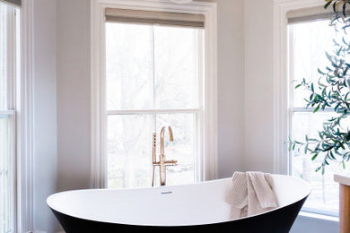 Example of a large transitional master black tile and ceramic tile marble floor, multicolored floor and double-sink bathroom design in Boston with flat-panel cabinets, light wood cabinets, a one-piece toilet, beige walls, an undermount sink, quartz countertops, white countertops, a niche and a freestanding vanity