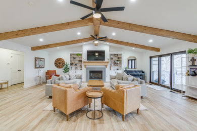 Example of a large transitional enclosed porcelain tile, beige floor and vaulted ceiling living room design in Oklahoma City with a standard fireplace and a tile fireplace