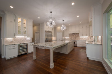 Inspiration for a large transitional u-shaped eat-in kitchen in Austin with an undermount sink, shaker cabinets, white cabinets, granite benchtops, grey splashback, porcelain splashback, stainless steel appliances, medium hardwood floors, with island, brown floor and multi-coloured benchtop.