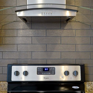Concave glass range hood with custom backsplash