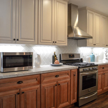 Antique white kitchen upper cabinet with cinnamon cabinets and Quartz countertop