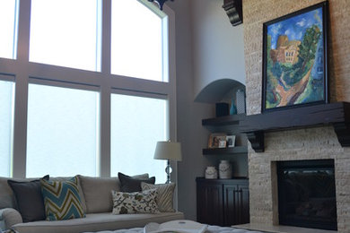 Example of a huge transitional open concept dark wood floor and brown floor living room design in Kansas City with gray walls, a standard fireplace, a stone fireplace and no tv
