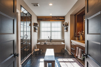 Design ideas for a large master bathroom in New York with flat-panel cabinets, medium wood cabinets, a freestanding tub, an alcove shower, beige walls, porcelain floors, an integrated sink, concrete benchtops, grey floor, a hinged shower door and beige benchtops.