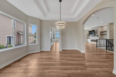 Dining room - transitional medium tone wood floor dining room idea in Denver with white walls, a standard fireplace and a tile fireplace