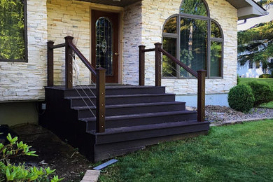 Mid-sized transitional beige one-story stone exterior home idea in New York with a shingle roof