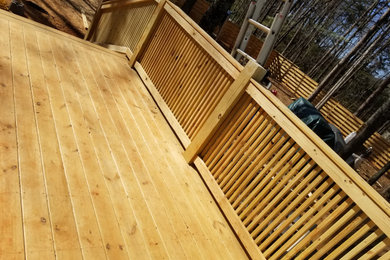 Example of a small transitional backyard ground level wood railing deck design in Charlotte with a bbq area and no cover