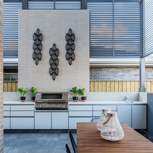 Inspiration for a large contemporary patio in Sydney with an outdoor kitchen and tile.