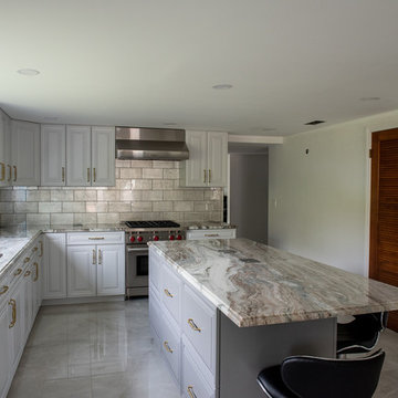 Transitional Kitchen Done in a 2 Tone Color With Integrated Dining Table