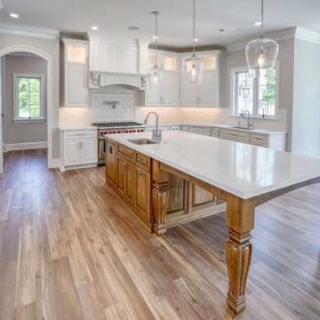 Transitional Kitchen with Two Toned Gathering Island & Archways