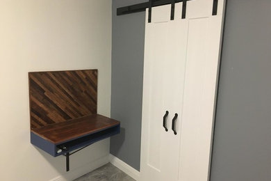 Example of a small trendy built-in desk light wood floor and gray floor home studio design in New Orleans with gray walls