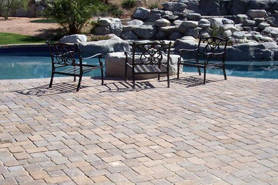 Minimalist backyard brick and custom-shaped natural pool fountain photo in Phoenix