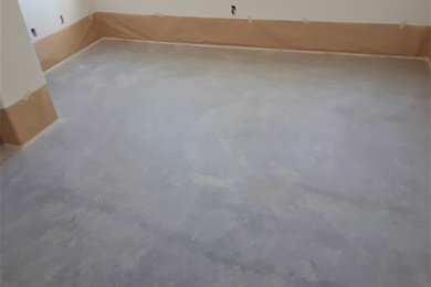 Large mountain style guest concrete floor and gray floor bedroom photo in Albuquerque with white walls and no fireplace
