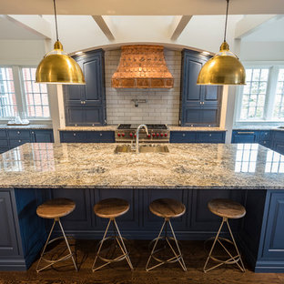 Large farmhouse kitchen pantry designs - Example of a large farmhouse l-shaped medium tone wood floor and brown floor kitchen pantry design in Cincinnati with a double-bowl sink, raised-panel cabinets, blue cabinets, granite countertops, gray backsplash, subway tile backsplash, stainless steel appliances and an island
